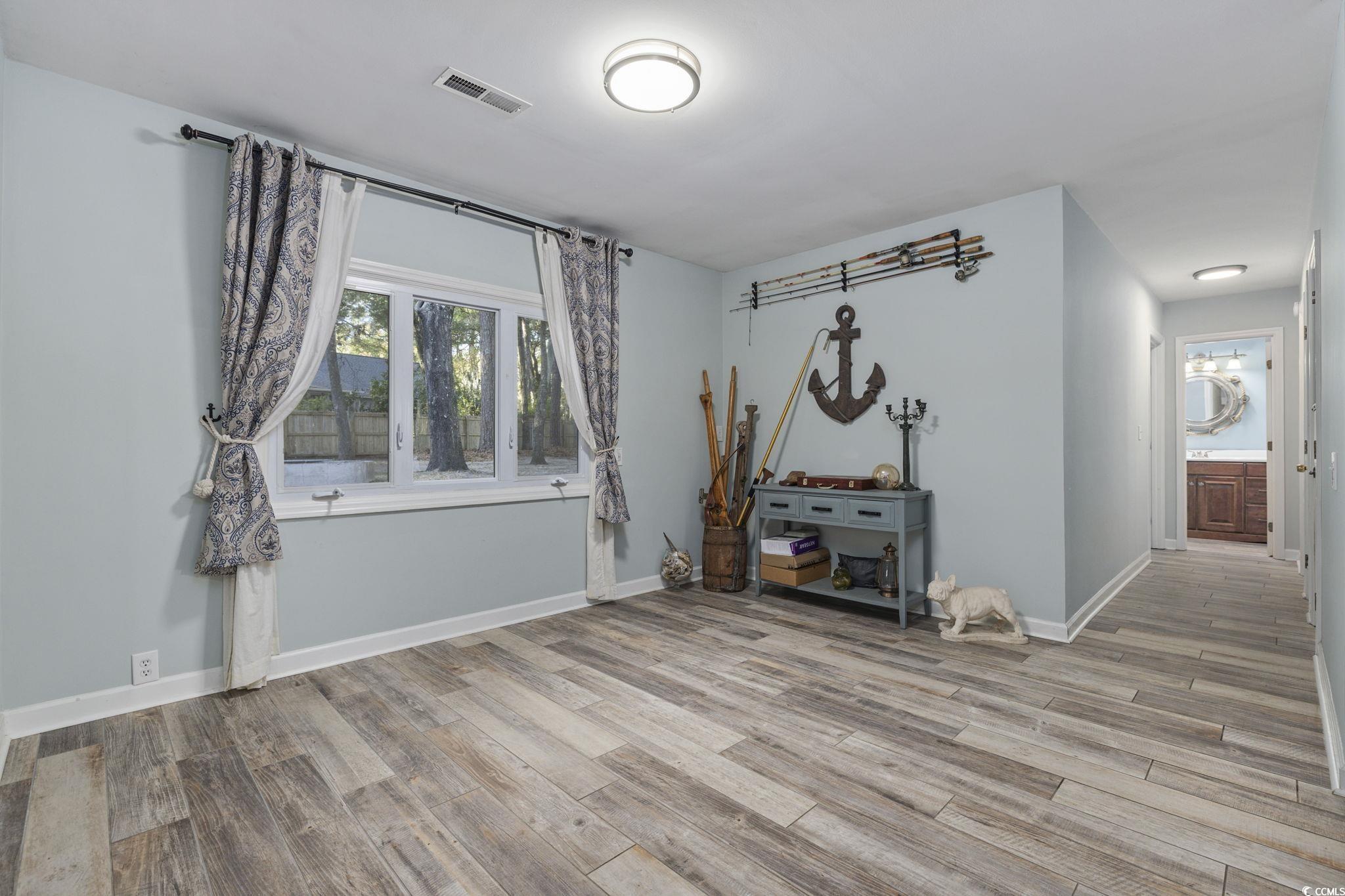 153 Watson Way Pawleys Island, SC 29585 - Photo 7 of 40 Unfurnished room featuring light wood-style floors and baseboards