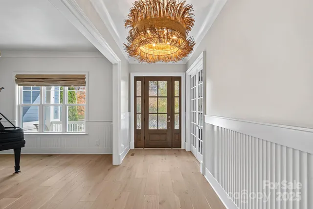 an empty room with a fireplace and windows