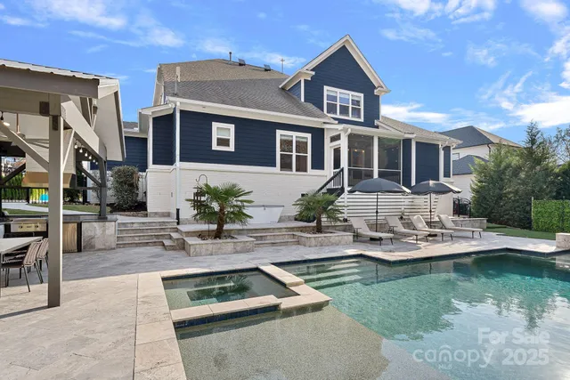a view of house with outdoor space and swimming pool
