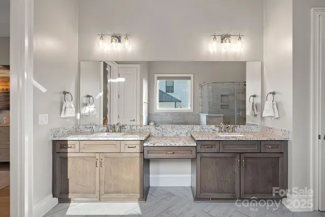 a bathroom with double sink and a mirror