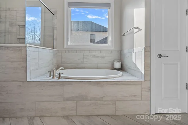 a bathroom with a bathtub and a shower