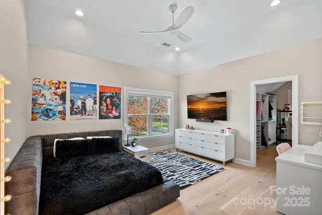a bedroom with furniture and a flat screen tv