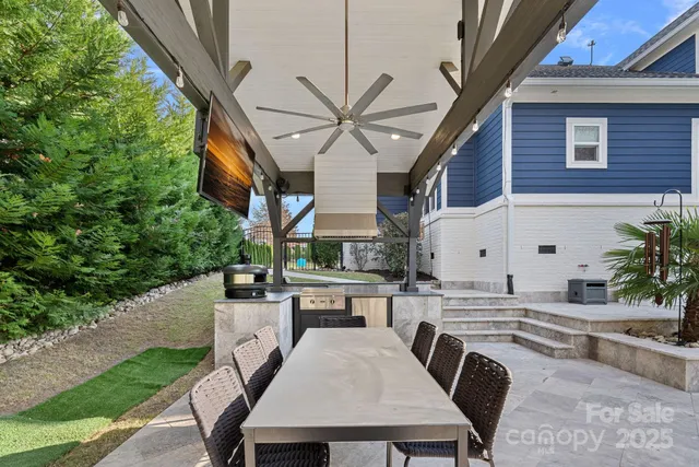 a view of a patio with table and chairs and potted plants