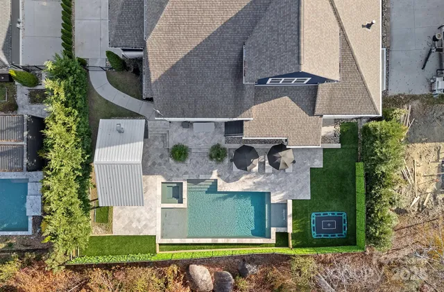 an aerial view of a house with a yard