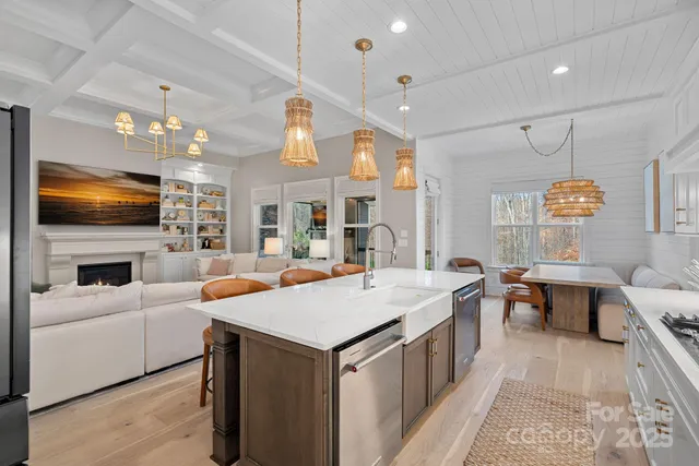 a view of living room kitchen with stainless steel appliances granite countertop living room
