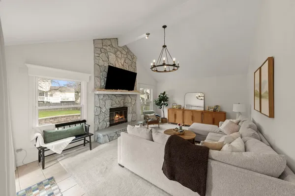 a living room with furniture a flat screen tv and a fireplace