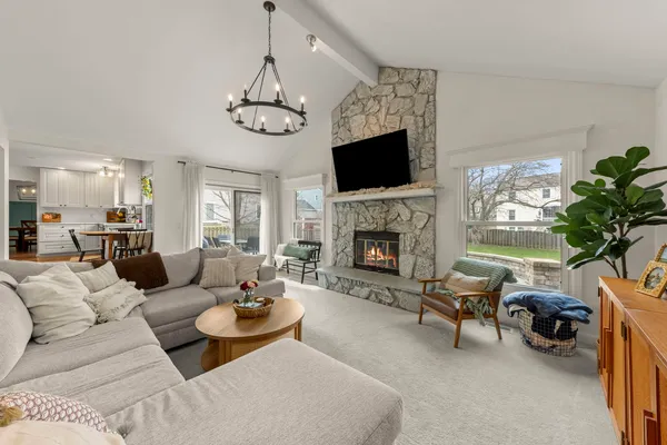 a living room with furniture a flat screen tv and a fireplace