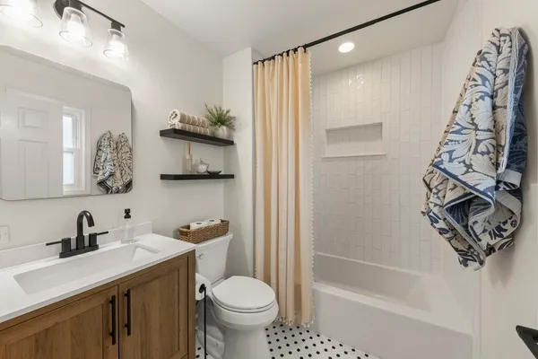 a bathroom with a sink toilet and shower