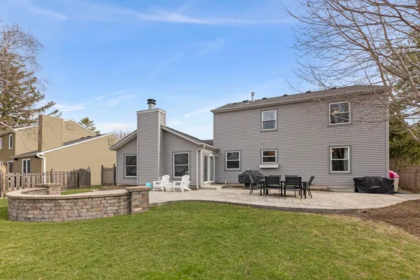 a view of a white house with a couches chairs and swimming pool with a yard