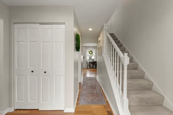 a view of a hallway with wooden floor and entryway