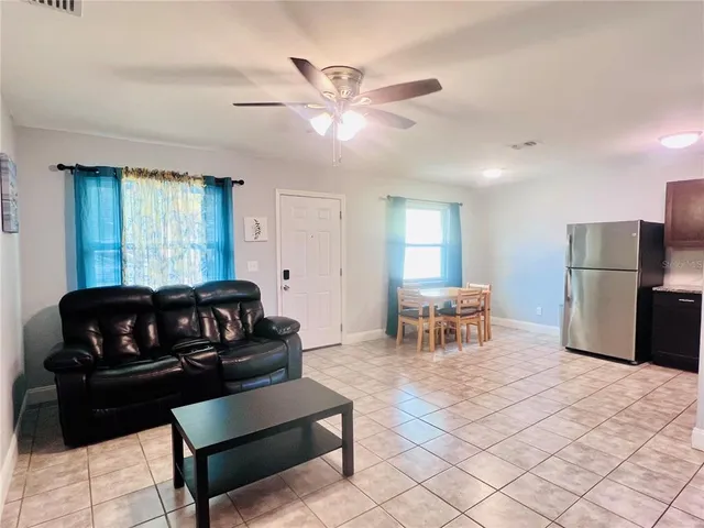 a living room with furniture and a chandelier