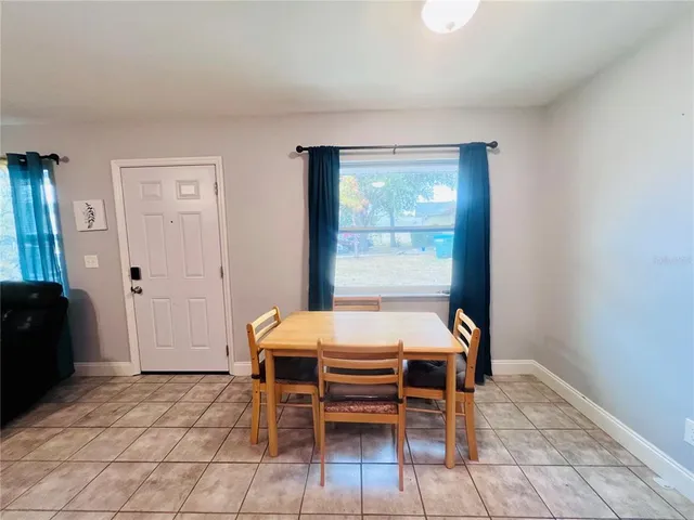 a dining room with furniture and window