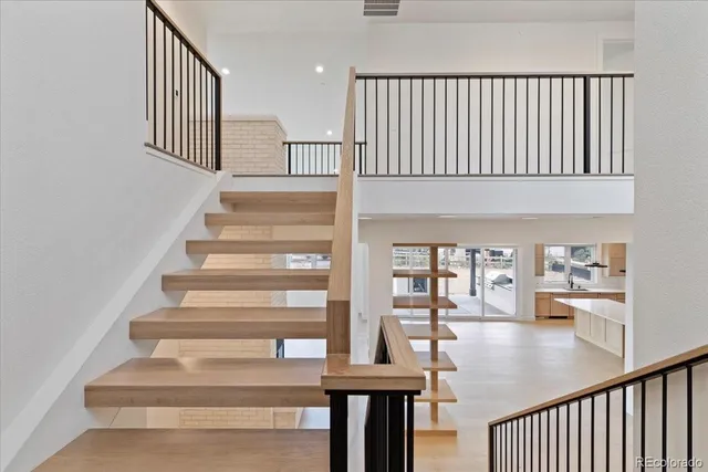 a view of entryway and hall with wooden floor