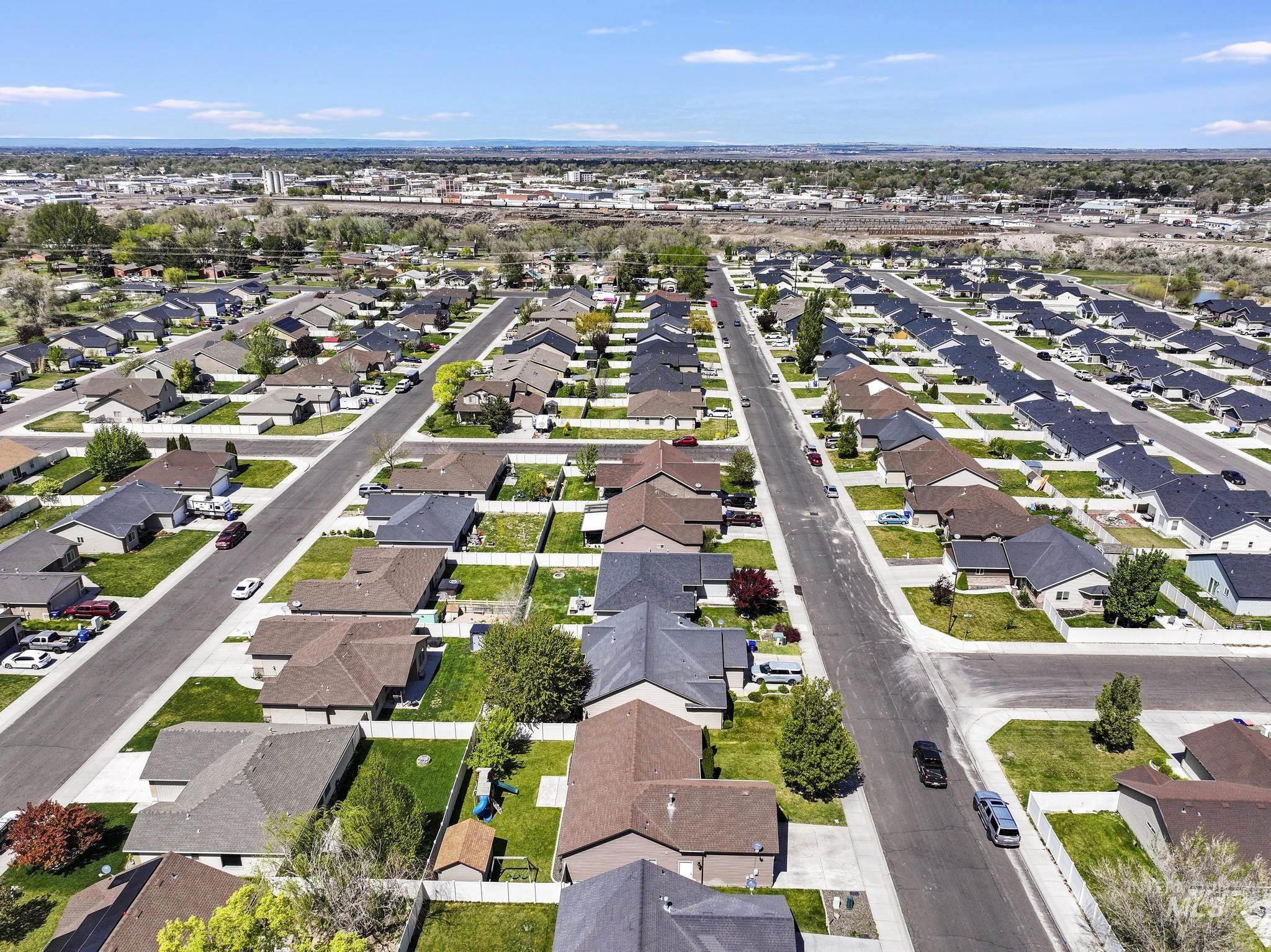 446 Noble Street Twin Falls, ID 83301 - Photo 38 of 42 Aerial perspective of a developed residential area featuring asphalt streets, concrete sidewalks, and a variety of single-story homes with shingle roofs