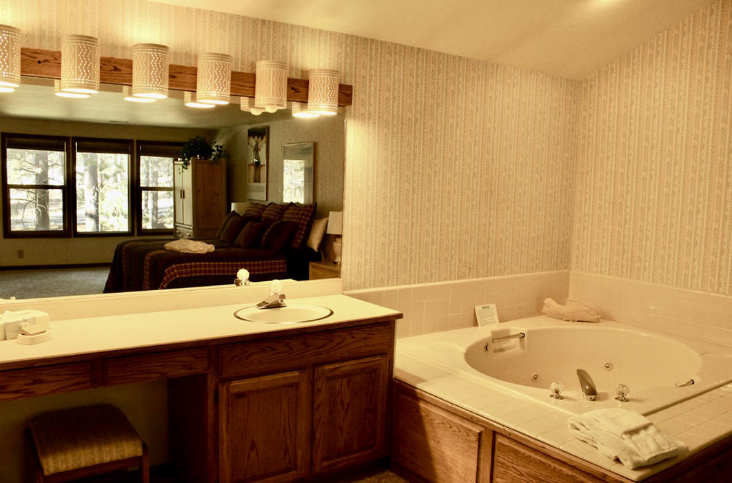 57326-12 Beaver Ridge Loop Sunriver, OR 97707 - Photo 14 of 24 a bathroom with a tub sink and mirror