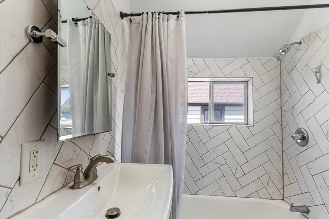 a bathroom with a tub and a sink
