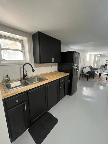 a kitchen with a sink and cabinets