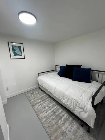 a bedroom with a bed and a lamp