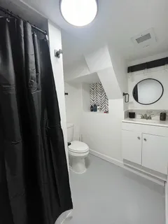 a bathroom with a granite countertop sink toilet and shower