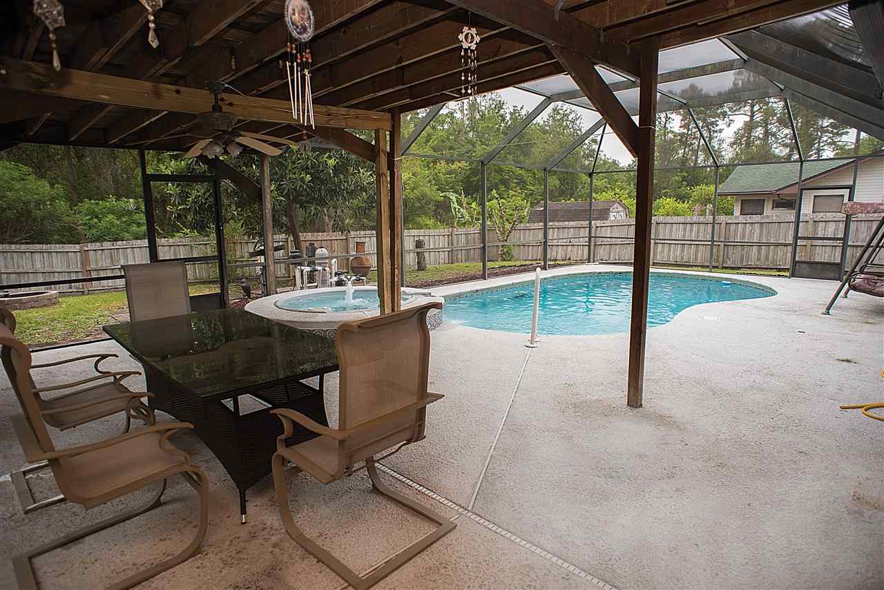503 Royal Road St. Augustine, FL 32086 - Photo 32 of 34 a view of a patio with a table chairs and a backyard