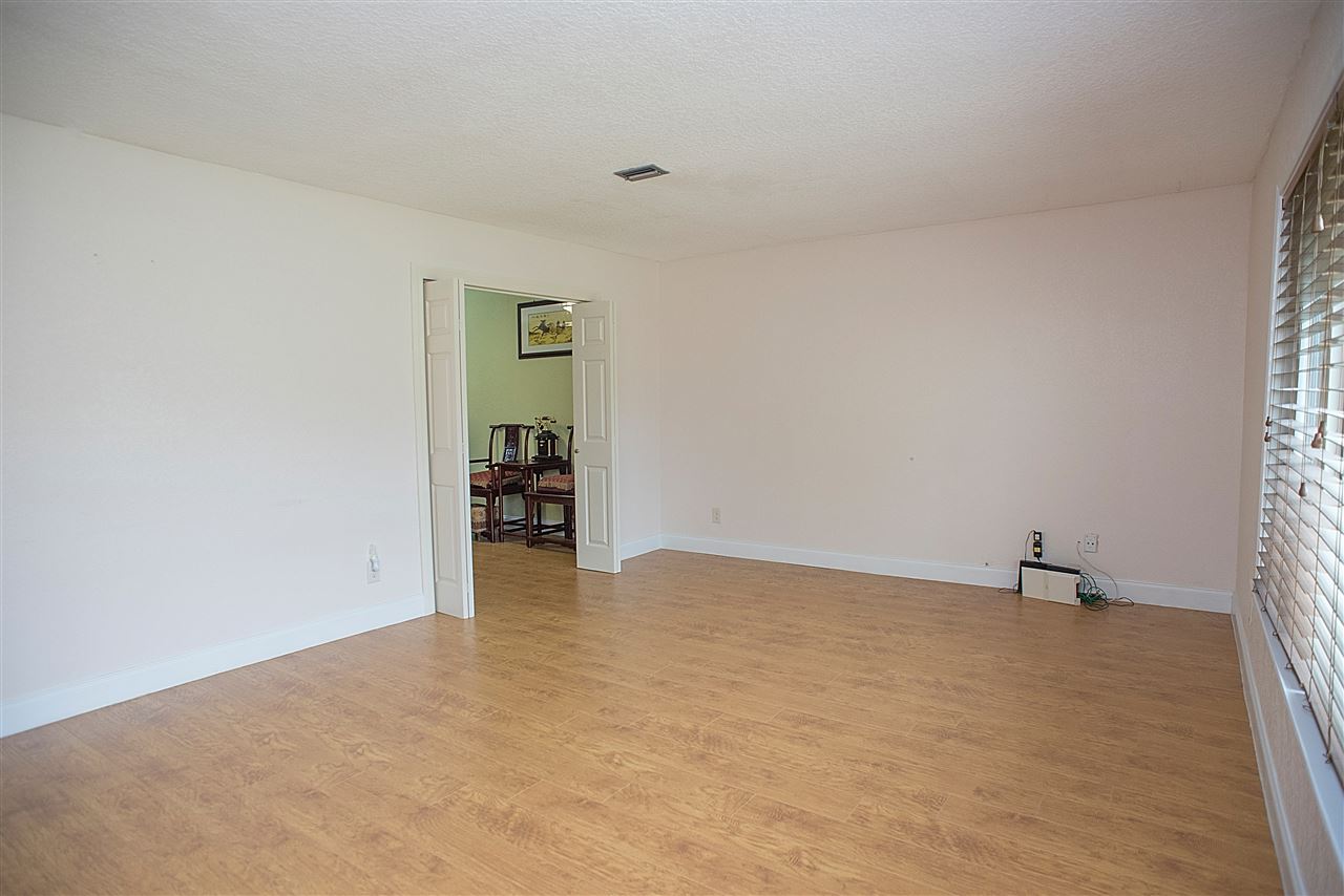 503 Royal Road St. Augustine, FL 32086 - Photo 5 of 34 a view of an empty room with wooden floor and a window