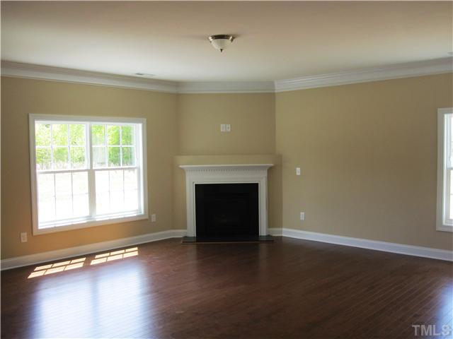 7608 Birchmoor Way, Unit LT75 Raleigh, NC 27616 - Photo 5 of 12 a view of an empty room with wooden floor and a window