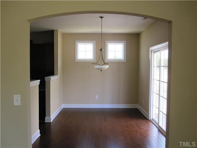 7608 Birchmoor Way, Unit LT75 Raleigh, NC 27616 - Photo 6 of 12 an empty room with wooden floor and windows