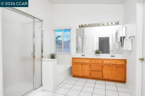 a spacious bathroom with a mirror a sink and a bathtub