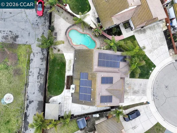 an aerial view of a house with garden space and balcony