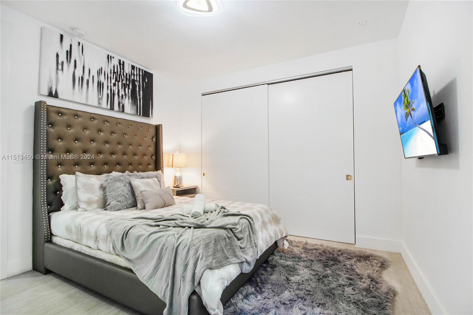 1500 Southwest 4th Avenue Miami, FL 33129 - Photo 13 of 24 a bedroom with a large bed and a painting on the wall