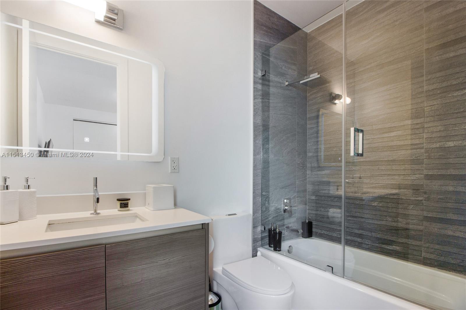 1500 Southwest 4th Avenue Miami, FL 33129 - Photo 14 of 24 a bathroom with a sink mirror toilet and bathtub