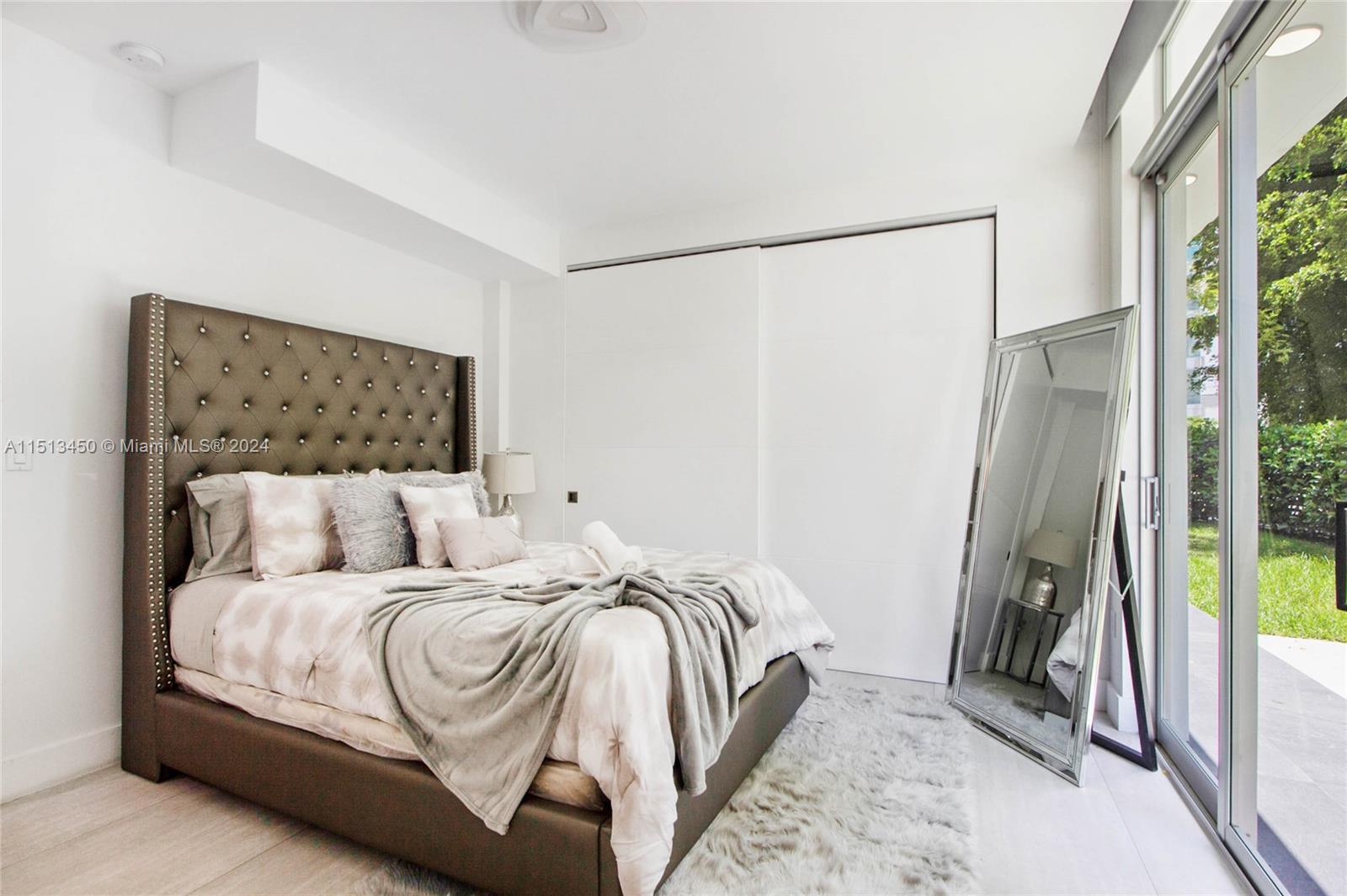 1500 Southwest 4th Avenue Miami, FL 33129 - Photo 15 of 24 a bedroom with a bed and a mirror