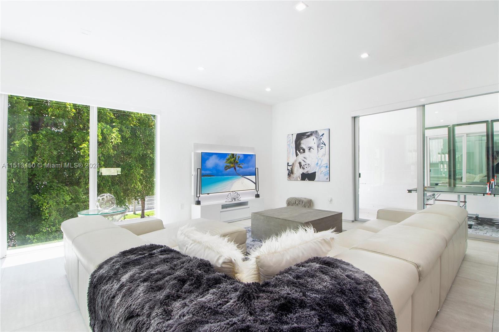 1500 Southwest 4th Avenue Miami, FL 33129 - Photo 19 of 24 a living room with large window couches and a flat screen tv