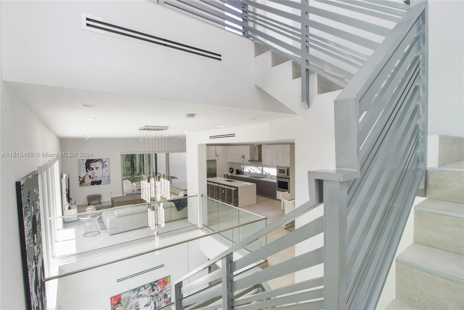 1500 Southwest 4th Avenue Miami, FL 33129 - Photo 5 of 24 a kitchen with stainless steel appliances kitchen island granite countertop a refrigerator and cabinets