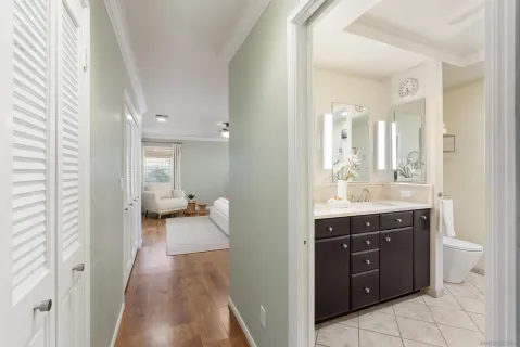 a en suite bathroom with a sink vanity granite and a mirror