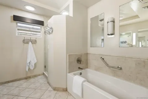 a bathroom with a bathtub and shower