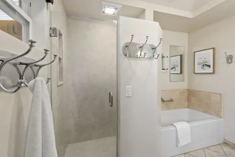 a bathroom with a bathtub and shower