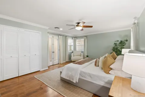 a bedroom with a bed and a chandelier