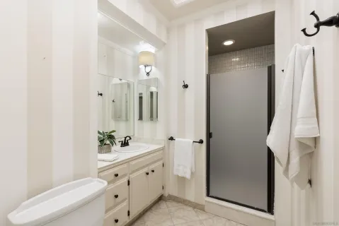 a bathroom with a double vanity sink mirror and toilet
