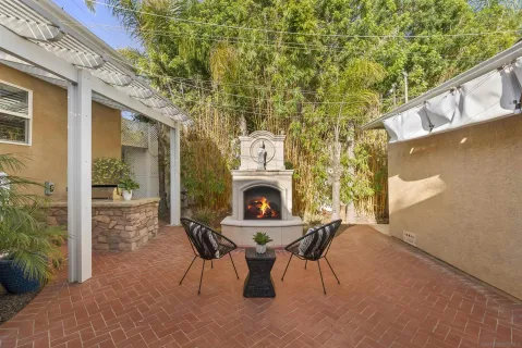 a view of a fireplace with a table and chairs