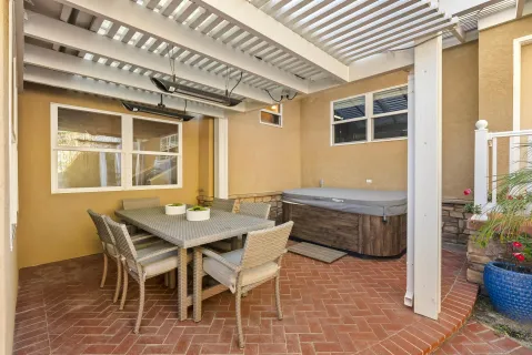 a view of a dining room with furniture and potted plants
