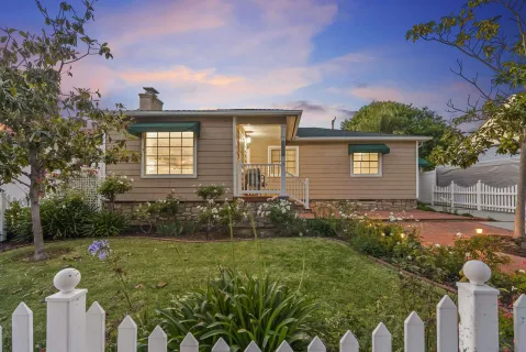 a view of a house with backyard and sitting area