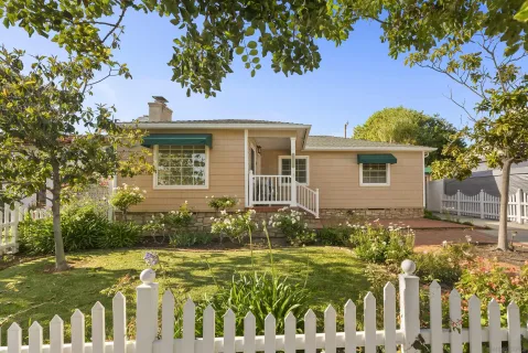 a front view of a house with a garden