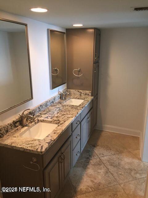 1601 Ocean Drive South, Unit 309 Jacksonville Beach, FL 32250 - Photo 13 of 18 a bathroom with a granite countertop sink and a mirror