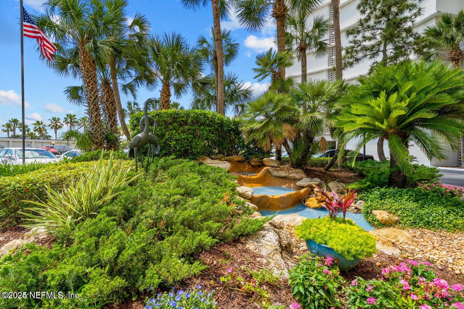 1601 Ocean Drive South, Unit 309 Jacksonville Beach, FL 32250 - Photo 15 of 18 a view of a garden with a palm tree