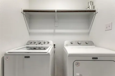 a bathroom with a granite countertop sink a toilet a mirror a bathtub and shower