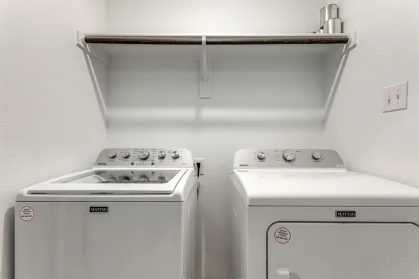 a bathroom with a granite countertop sink a toilet a mirror a bathtub and shower