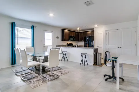 a living room with furniture a flat screen tv and a window