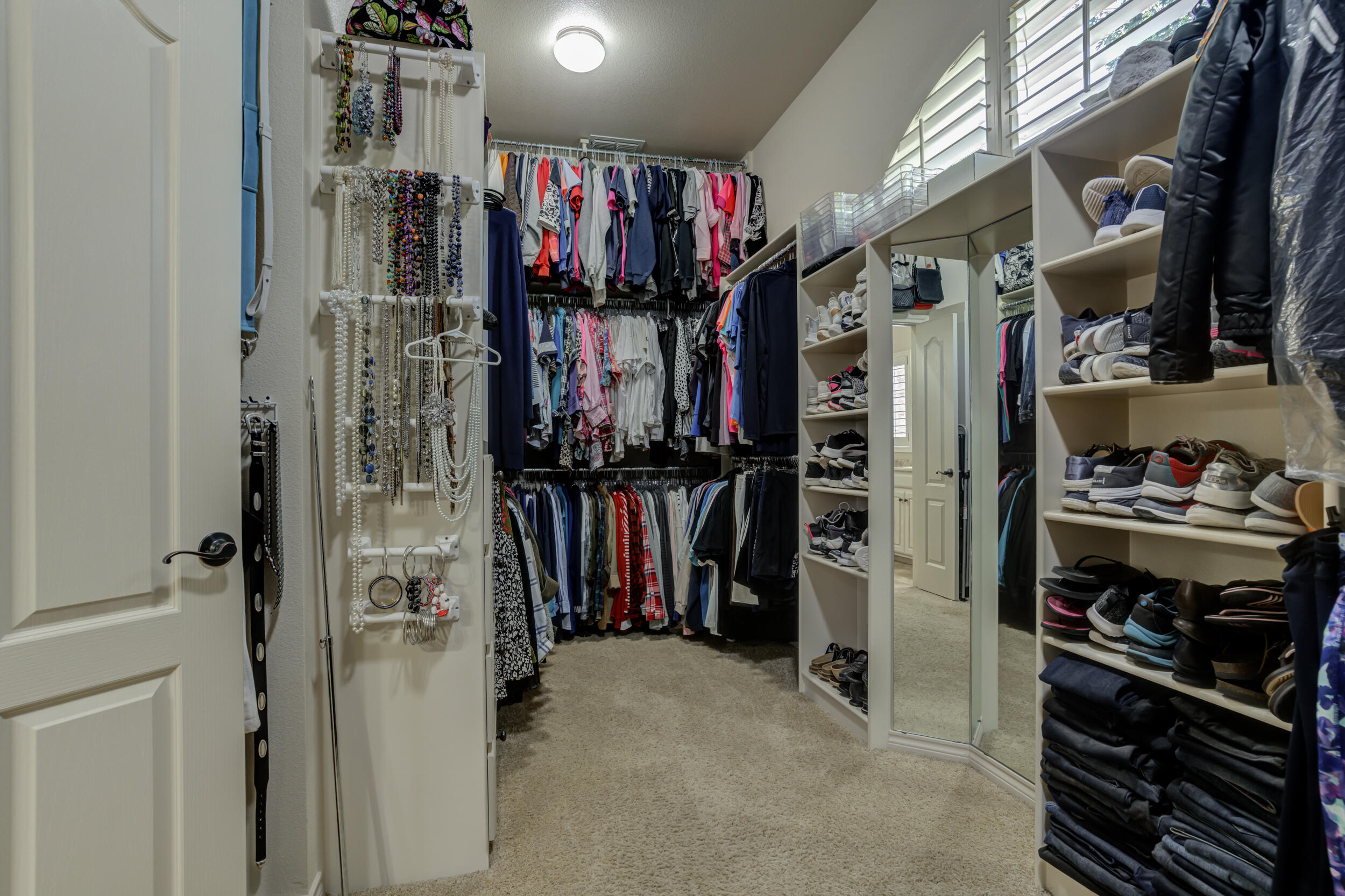 6008 89th Street Lubbock, TX 79424 - Photo 38 of 61 a view of walk in closet with clothes and shoes