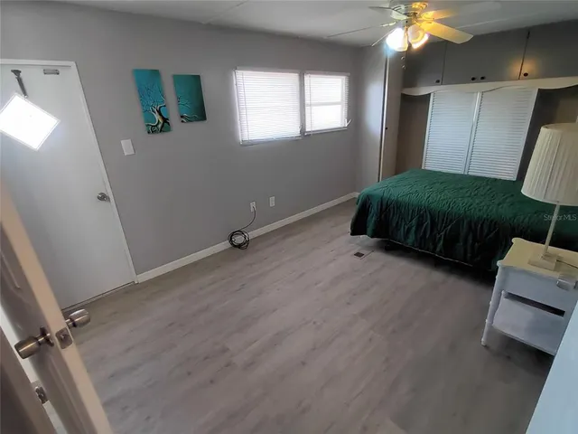 a bedroom with a bed a window and dresser